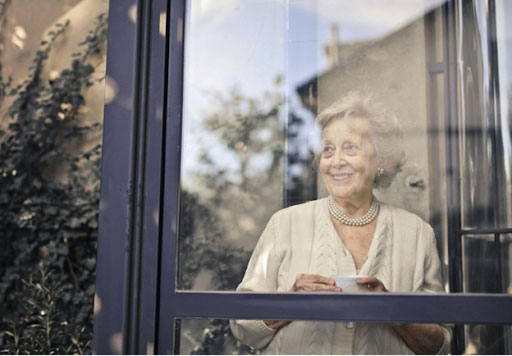 older woman sitting at window